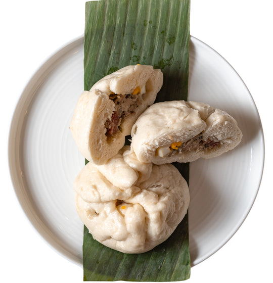 Laos dumplings on a banana leaf on a plate.