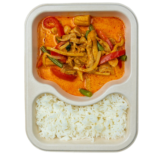 Spicy chicken curry soup with jasmine rice in a compostable meal tray.