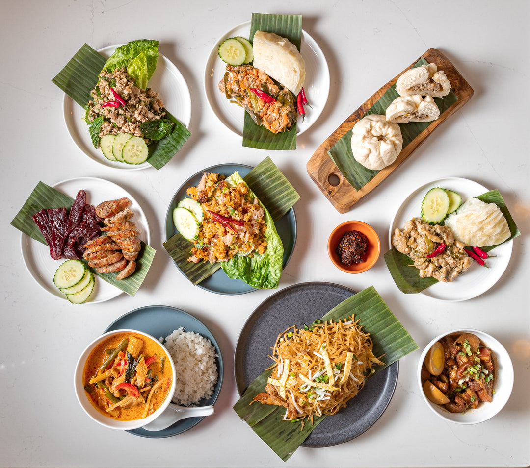 Nine Laos prepared meals displayed on plates.