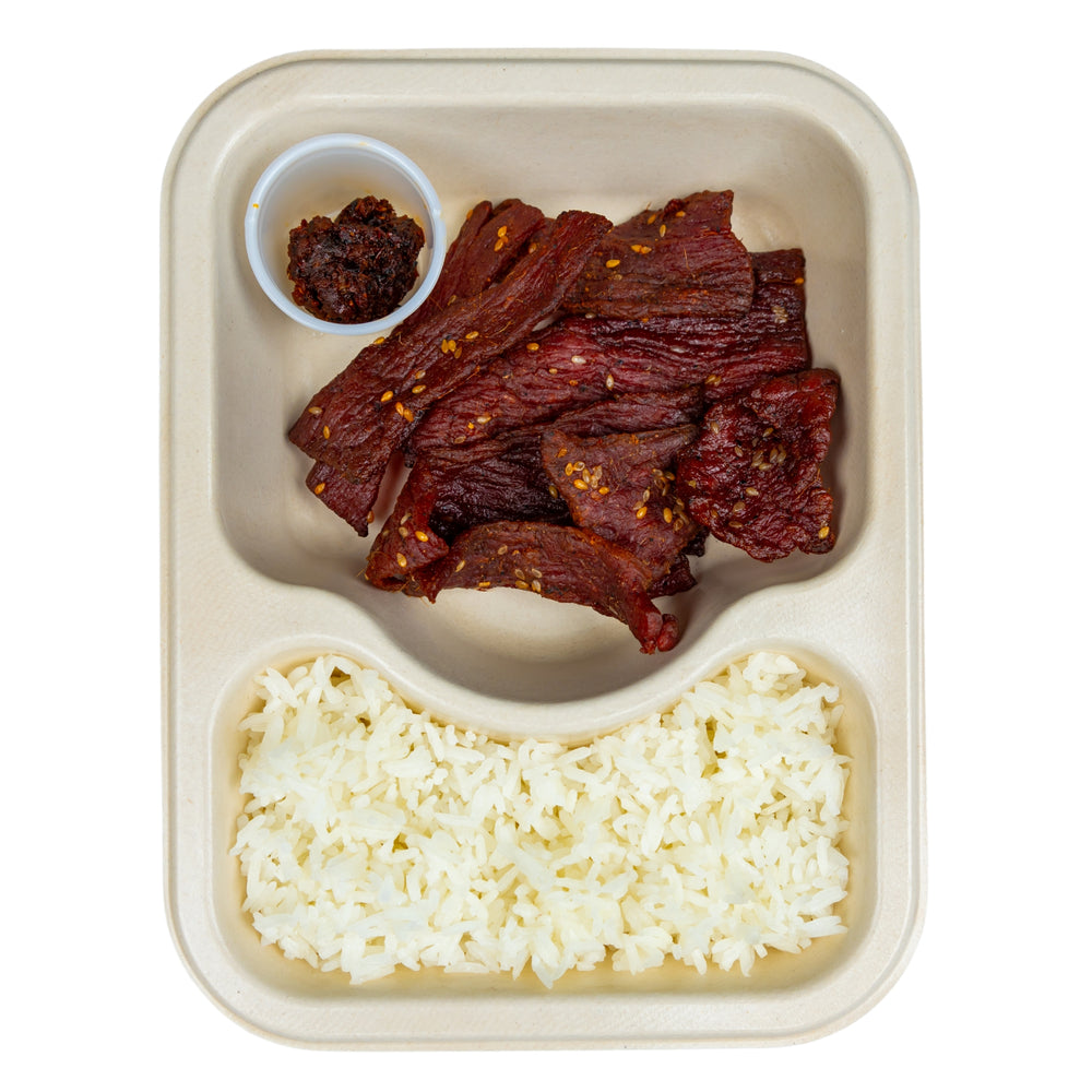 Lao Beef Jerky with jasmine rice in a compostable meal tray.